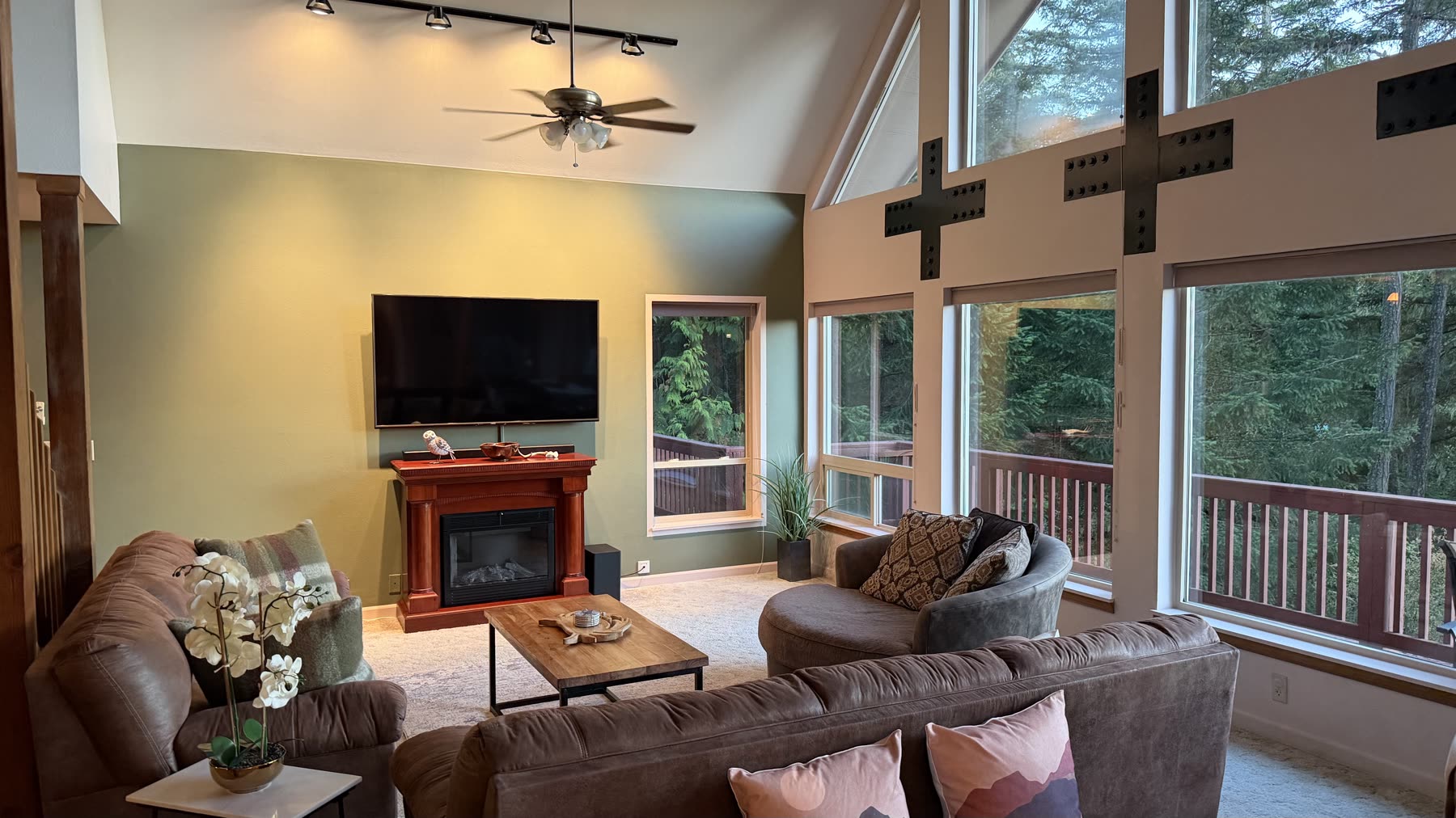 Great room seating around the hearth beneath vaulted ceilings