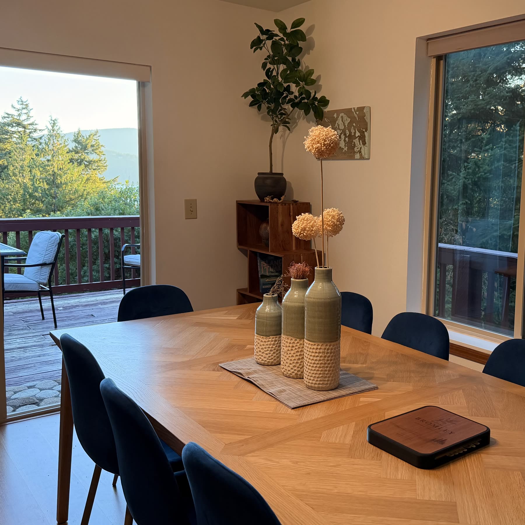Dining table for eight beside sliding doors to the deck